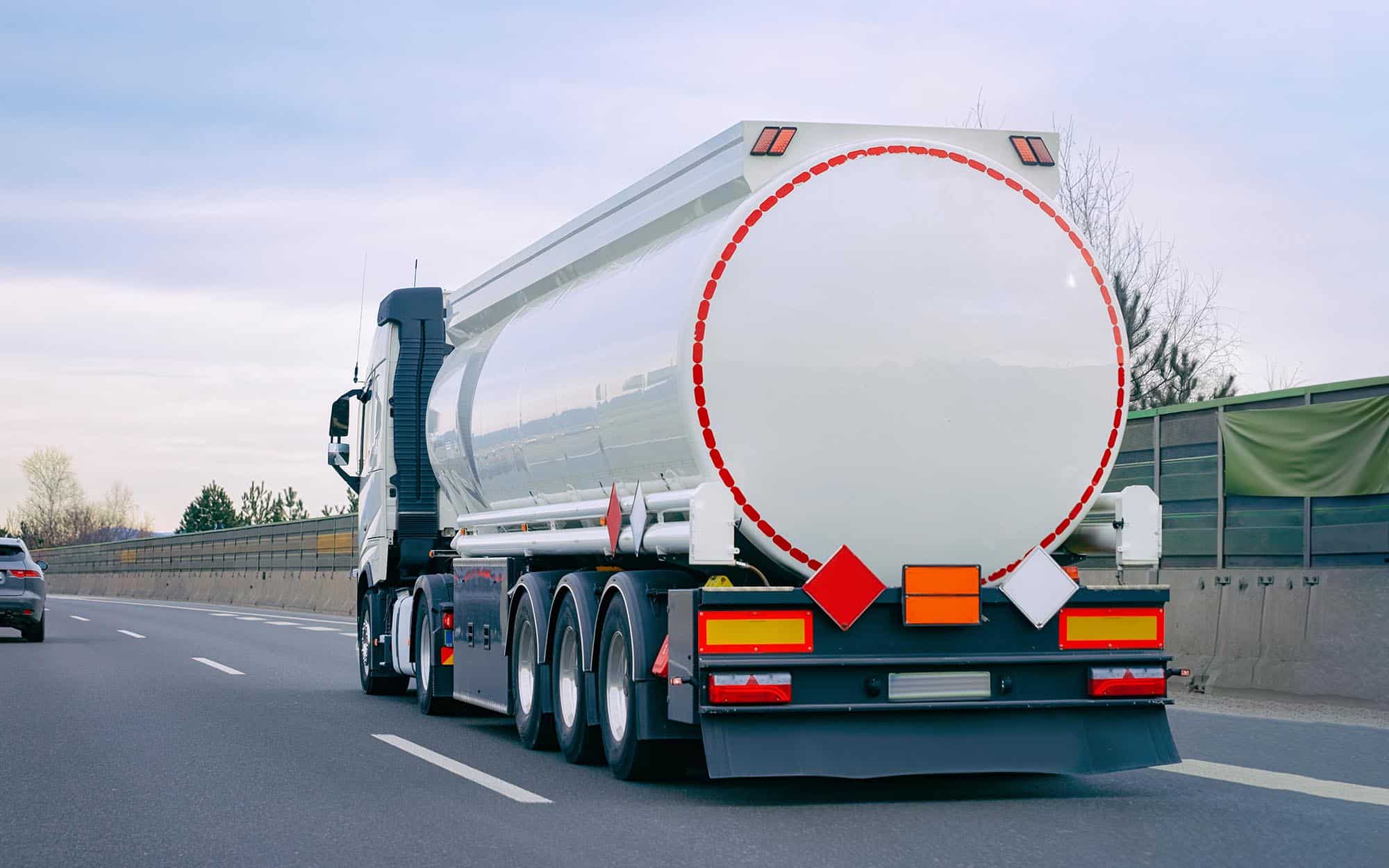 Side view of a semitruck driving down the highway