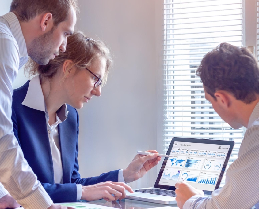 Group of people looking at analytics on computer