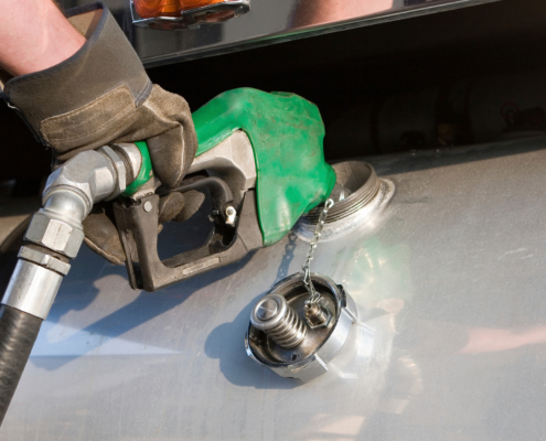 Side view of a semitruck being filled up with gas