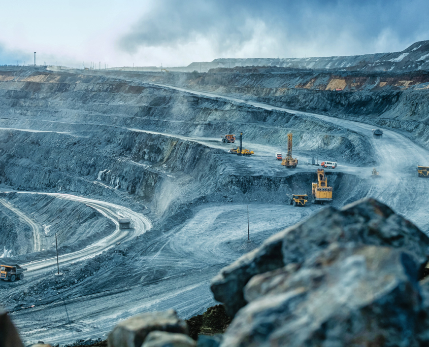 Work of trucks and the excavator in an open pit
