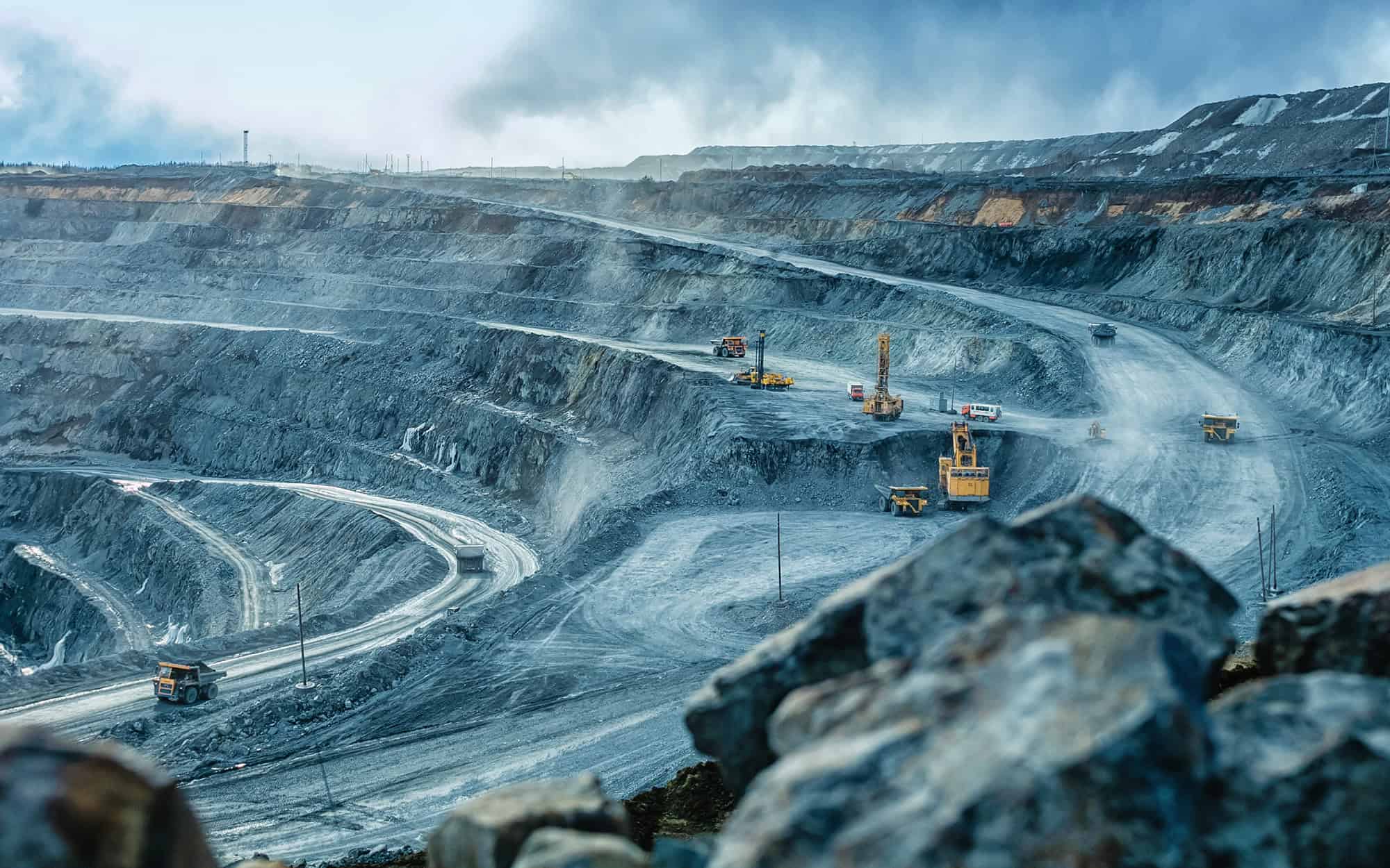 Work of trucks and the excavator in an open pit
