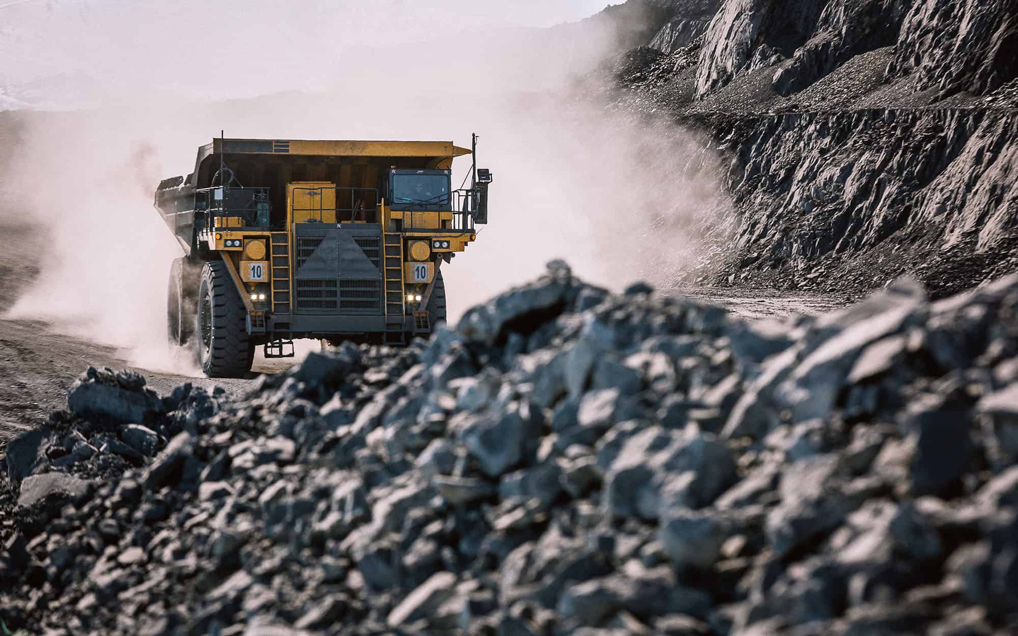 Career dump truck is going to the gold mining range