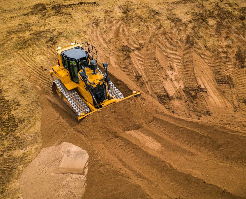 A-bull-dozer-pushes-sand-into-a-large-pile A Bull Dozer Pushes Sand Into A Large Pile