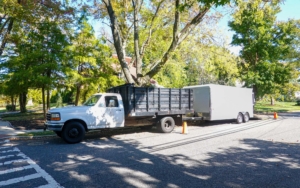 A White Landscaping Truck With A Long White Enclosed Trailer Trailer