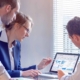 Group Of People Looking At Analytics On Computer
