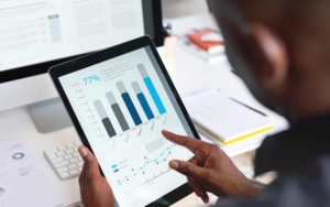 Person Looking At Data Analytics On Tablet