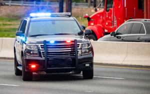 Road Patrol Police Car On Highway Scene With Emergency Lights