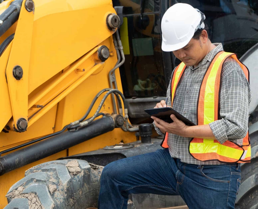 Worker Using Tablet For Fuel Inventory Management With Fleet Management Systems